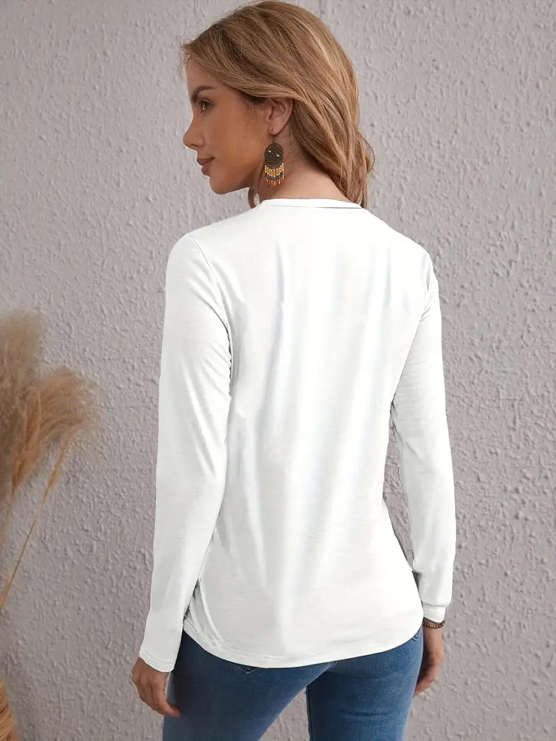 A woman wearing a white long sleeve t-shirt and blue denim jeans.