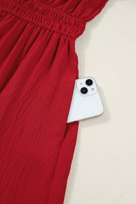 Red fabric with a smartphone lying on a beige surface