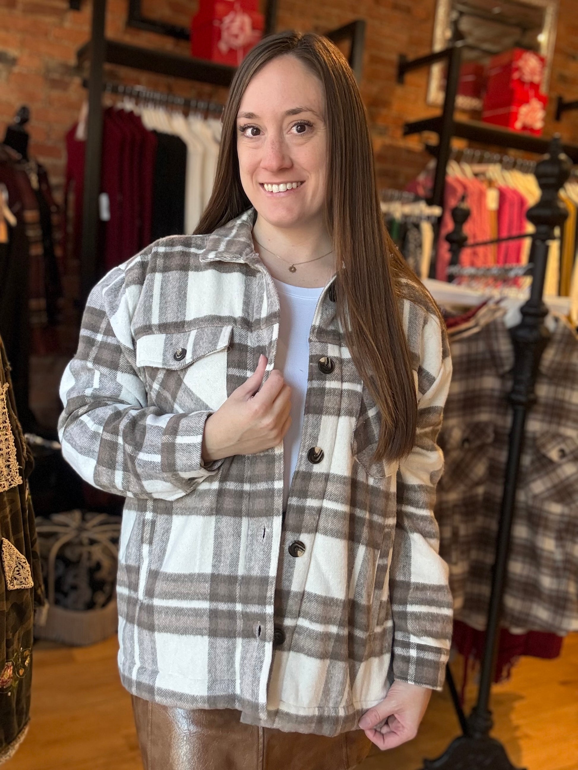 Woman wearing a plaid shirt in a clothing store