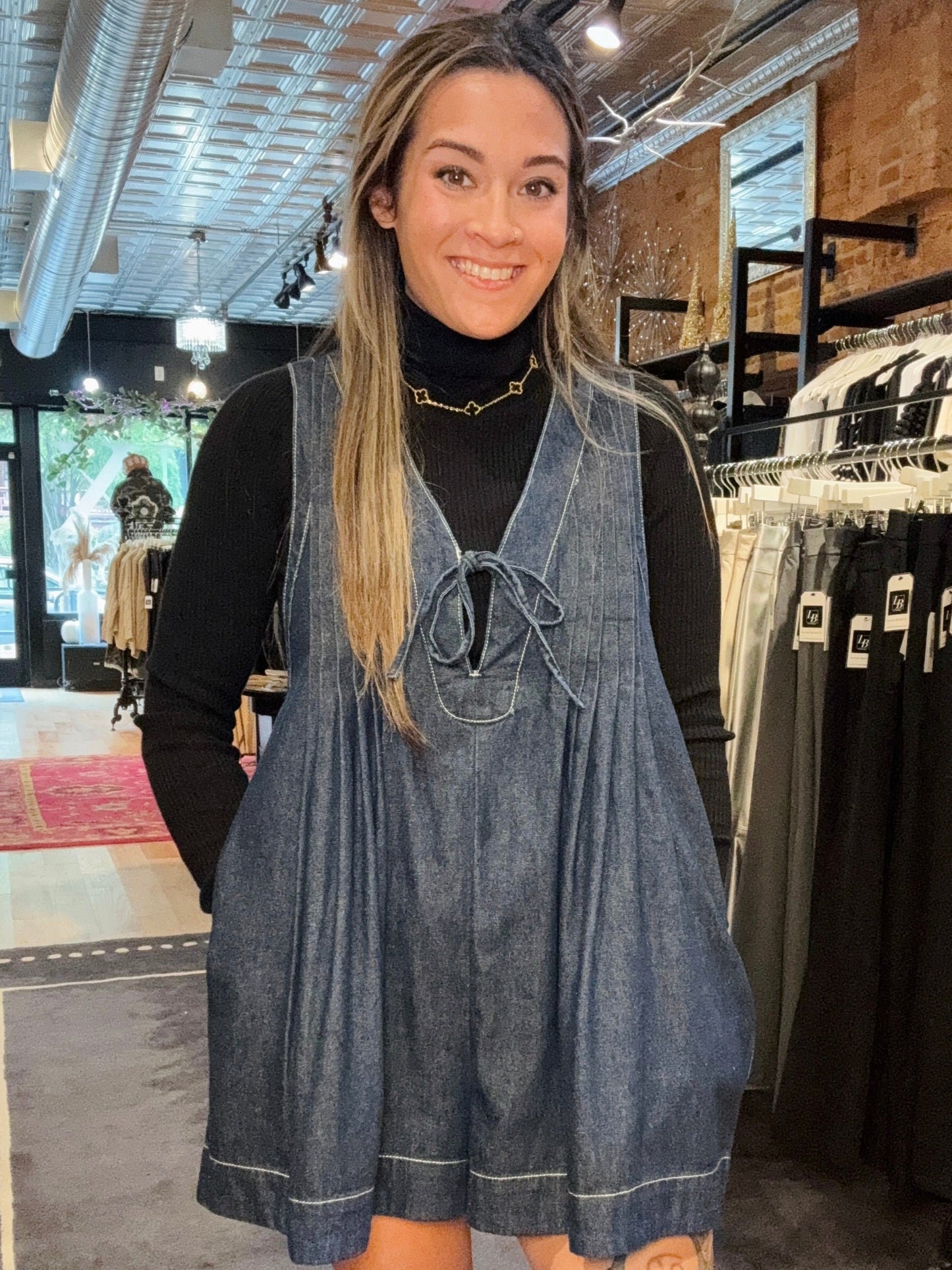 Woman wearing a denim dress in a clothing store