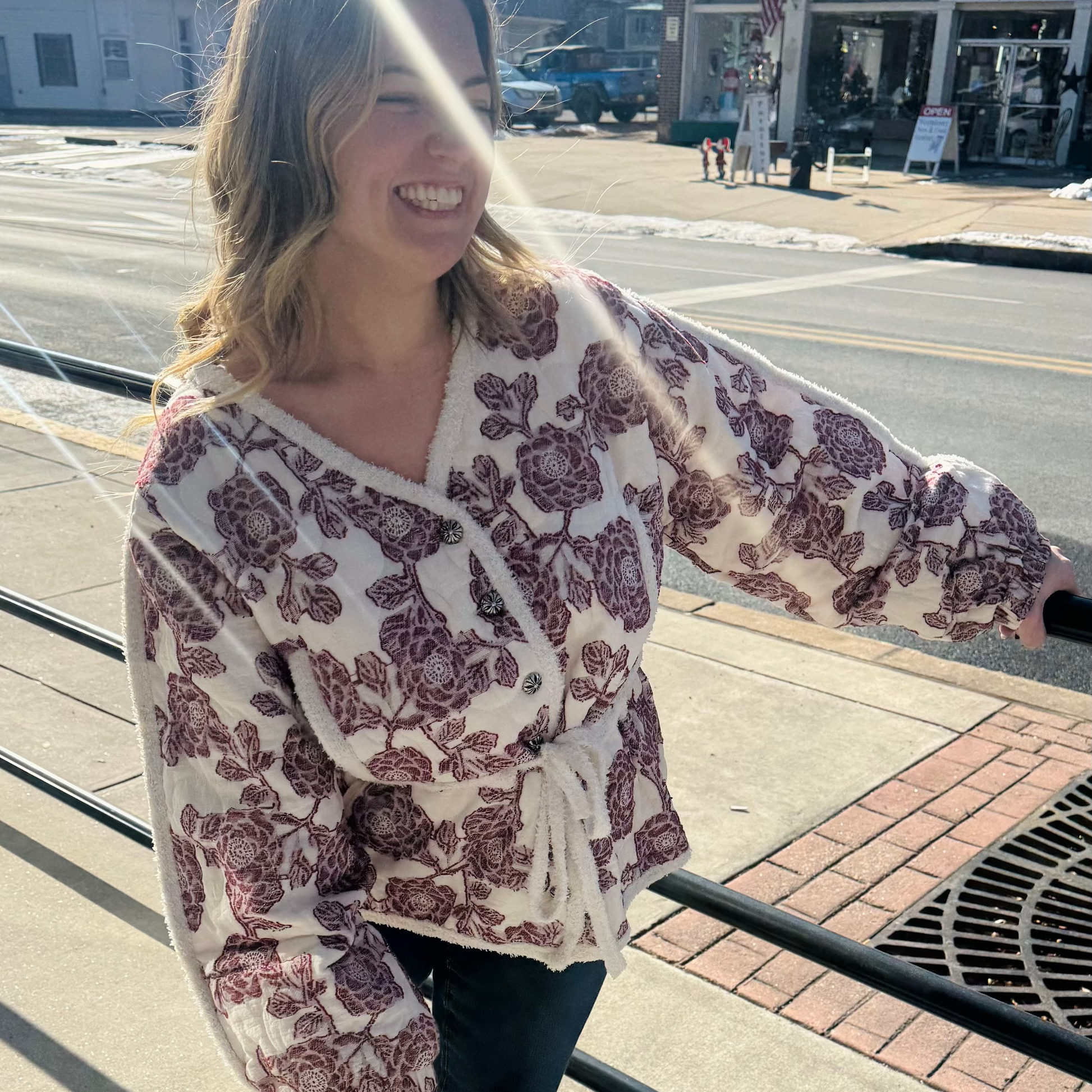 Woman wearing a floral cardigan on a city street