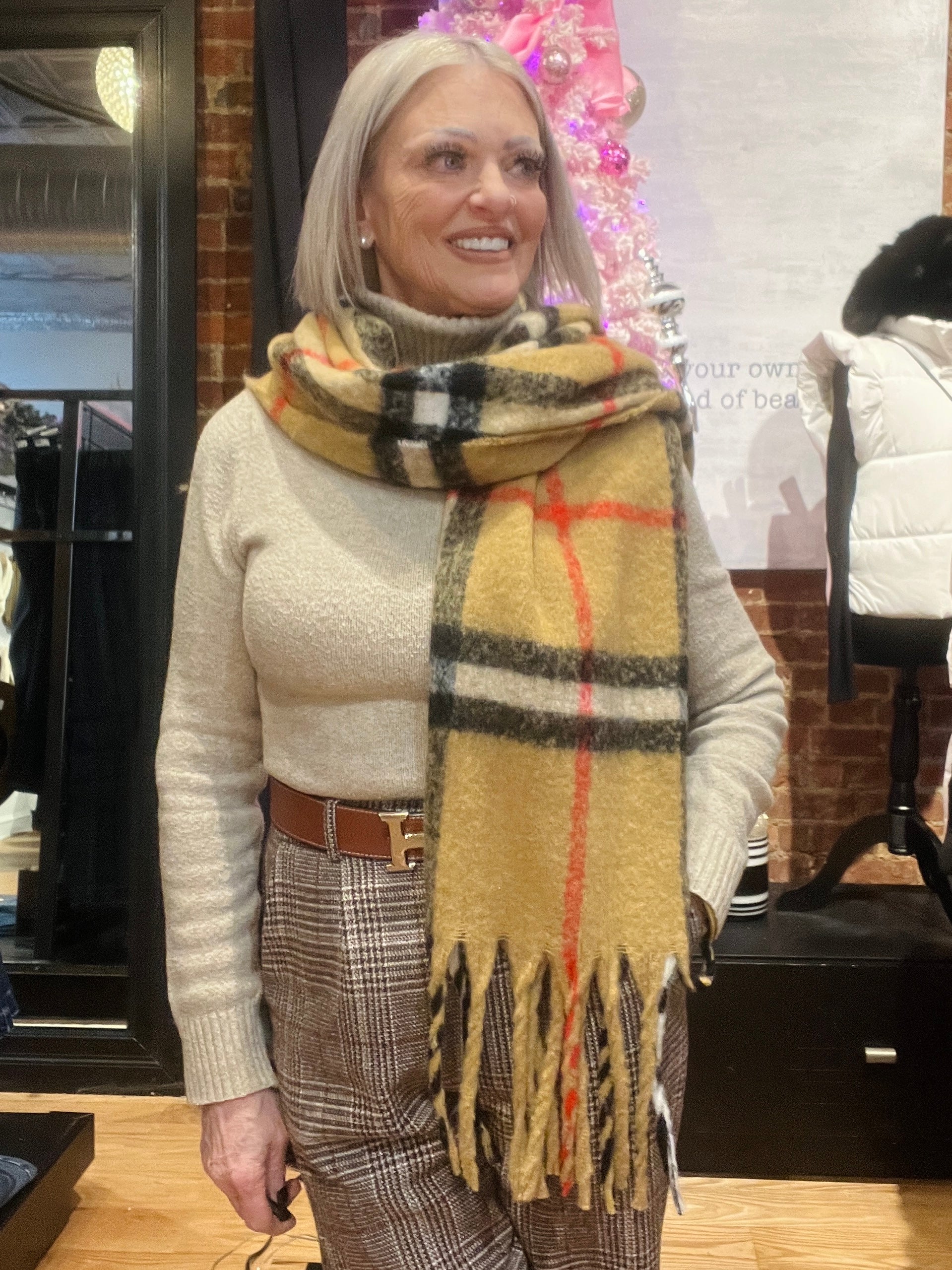 Woman wearing a checkered scarf in a store setting