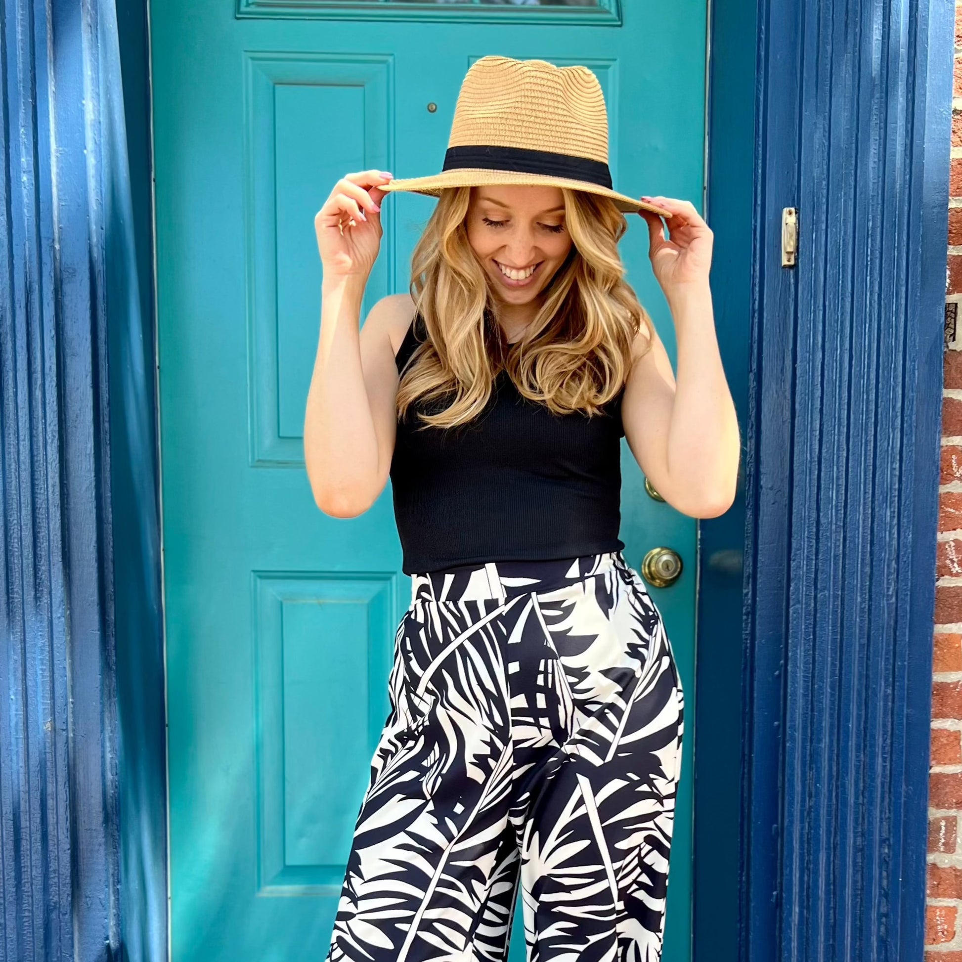 Black stretchy ribbed knit tank top with a figure-skimming fit and a high crew neckline