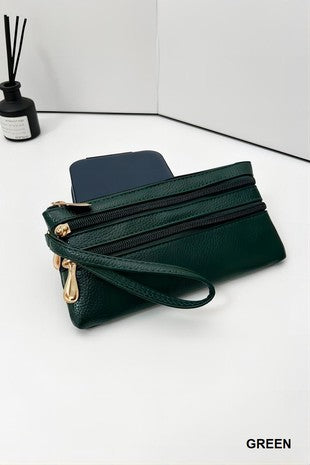Green wristlet with multiple zippers on a white surface, with 'GREEN' text at the bottom right corner.