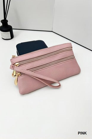 Pink clutch bag with gold zipper on a white surface