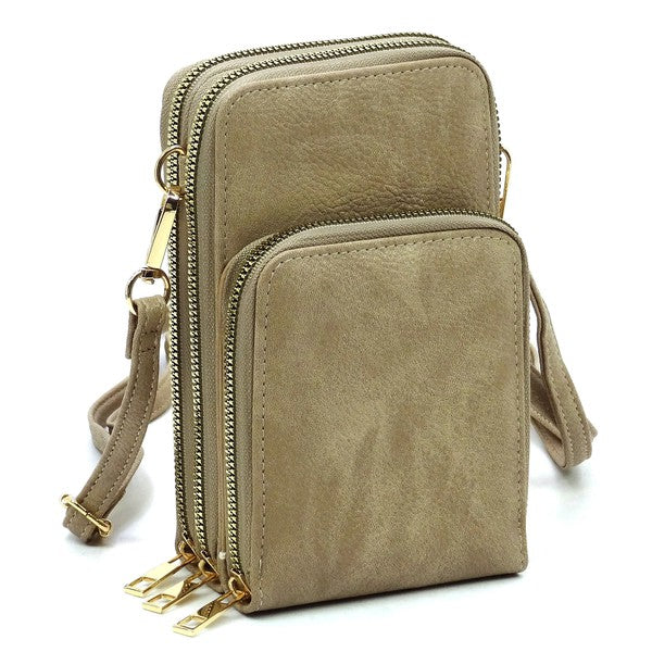 Beige crossbody bag with gold zippers on a white background