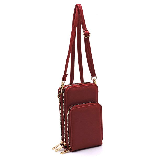 Red crossbody bag with gold accents on a white background