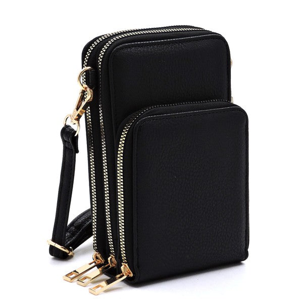 Black crossbody bag with gold zippers on a white background