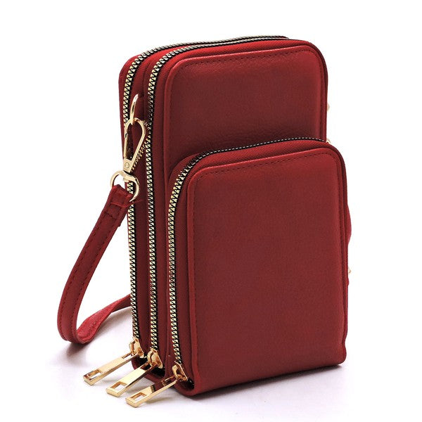 Red crossbody bag with gold zippers on a white background