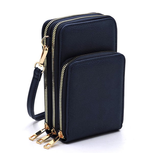 Navy blue crossbody bag with gold zippers on a white background