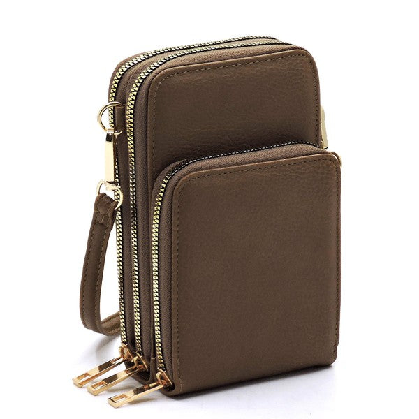 Brown leather crossbody bag with gold zippers on a white background