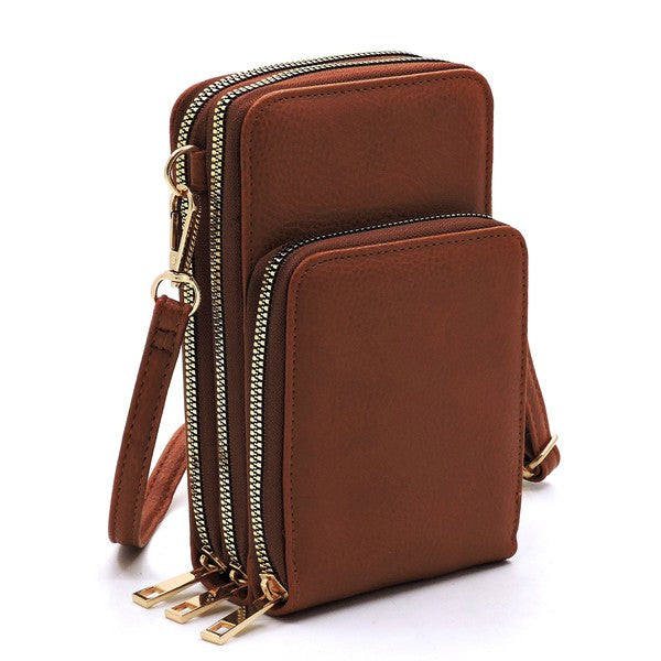 Brown leather crossbody bag with gold zippers on a white background