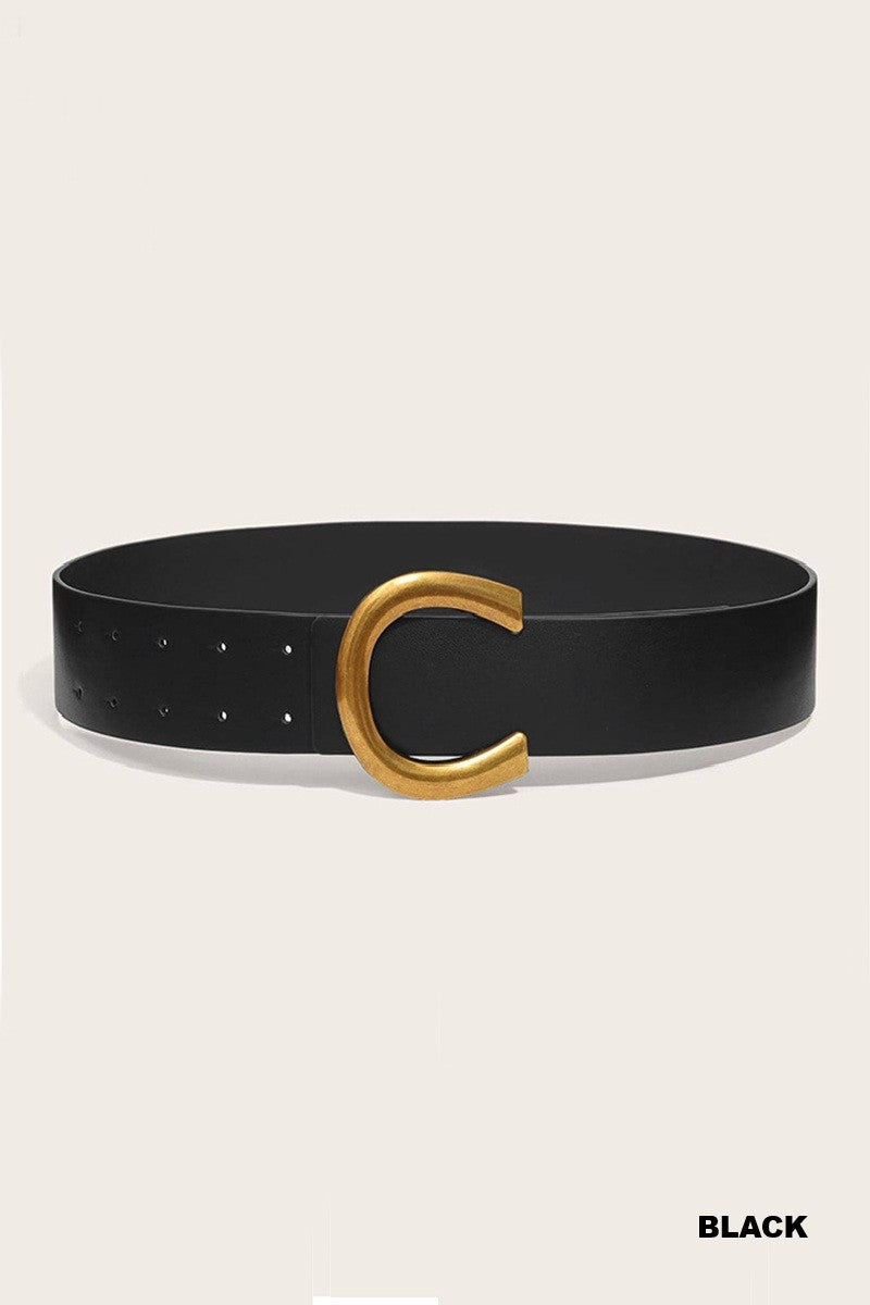 Black belt with a gold buckle on a beige background