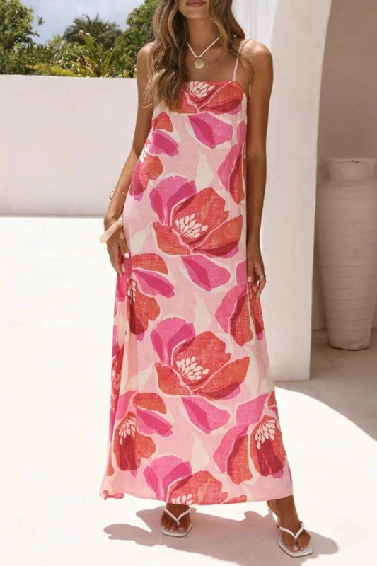 Woman wearing a pink floral dress in an outdoor setting
