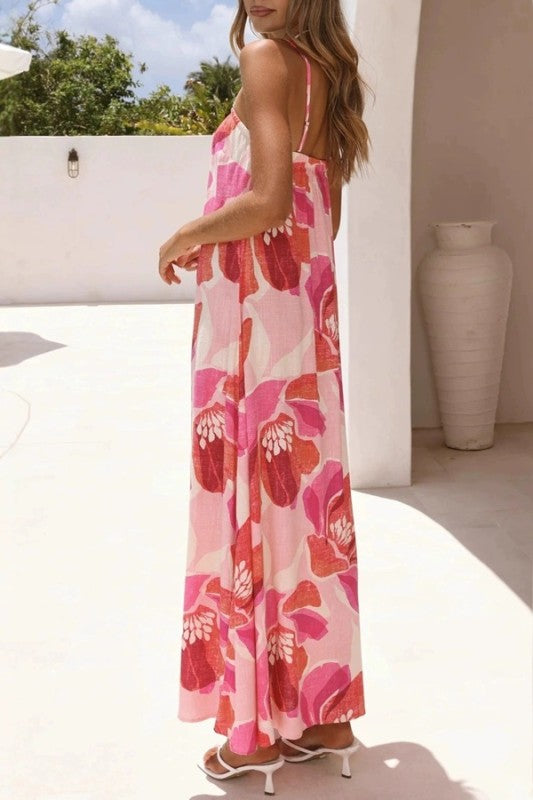 Woman wearing a pink floral dress in an outdoor setting