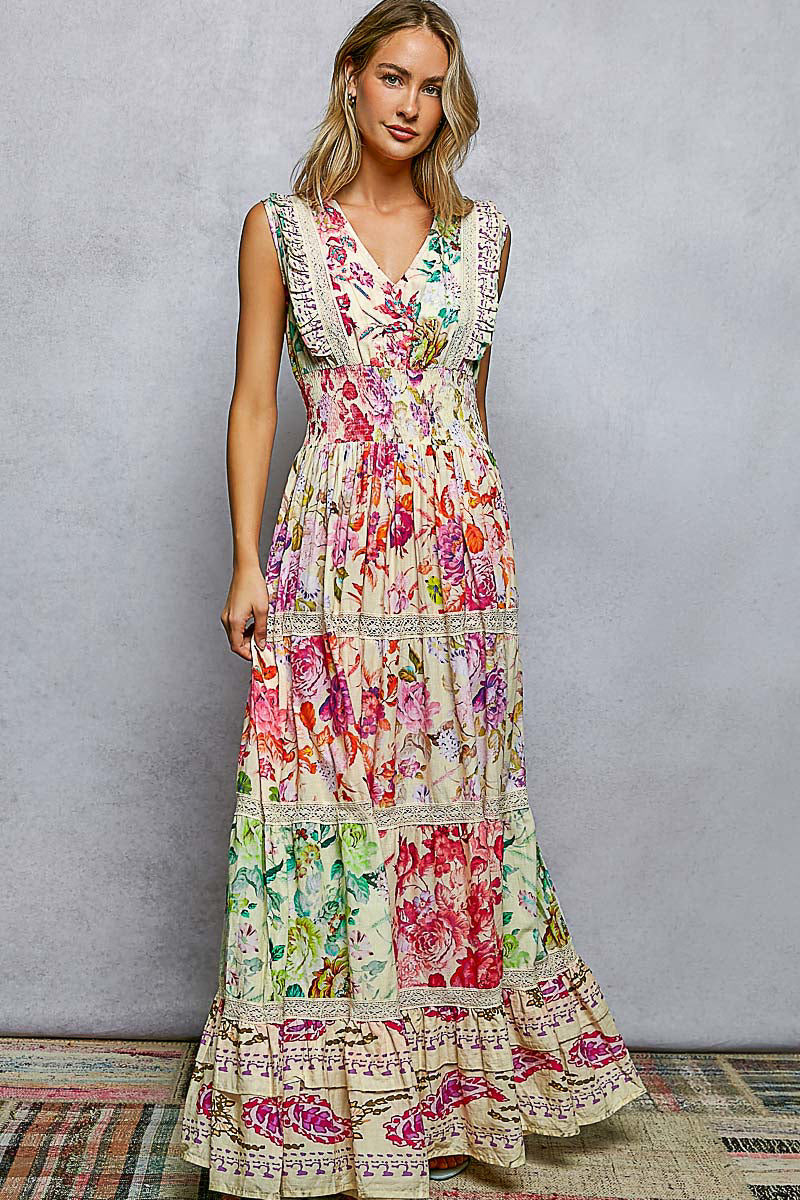 Woman wearing a colorful floral dress against a gray background