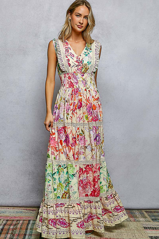 Woman wearing a colorful floral dress against a gray background