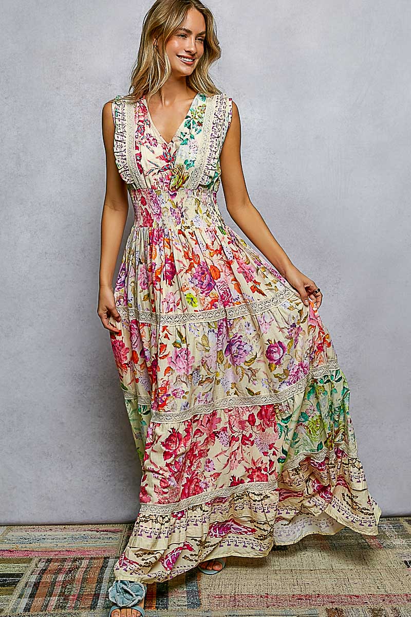 Woman wearing a colorful floral dress against a plain background