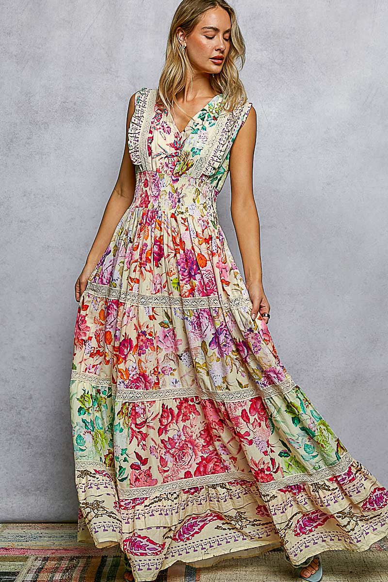 Woman wearing a colorful floral dress against a gray background