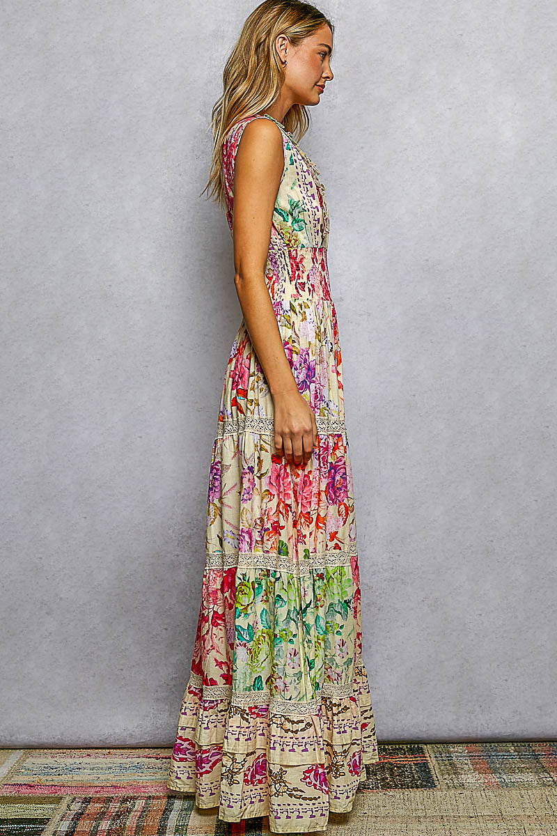 Woman wearing a colorful floral dress against a plain background