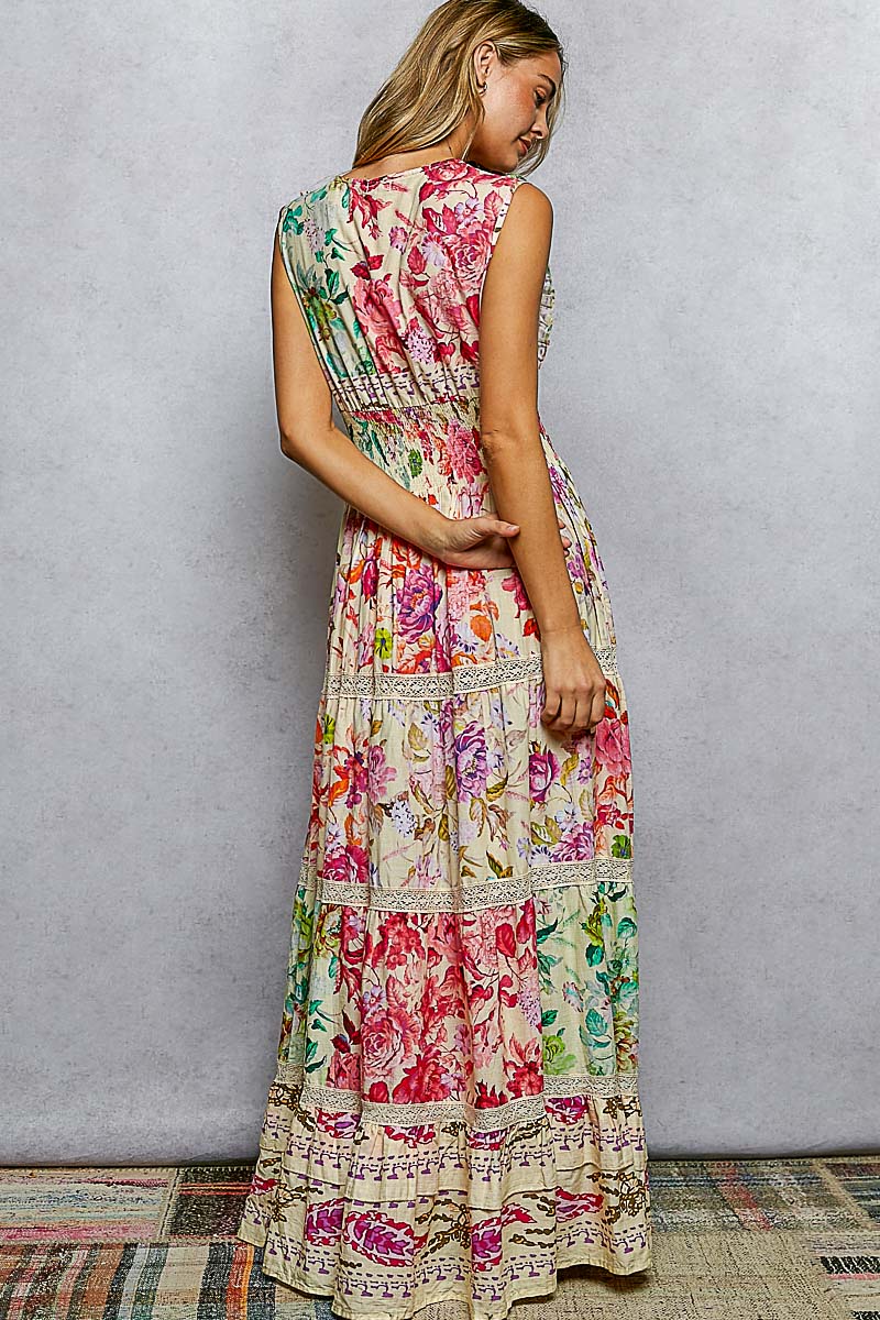 Woman wearing a colorful floral dress against a plain background