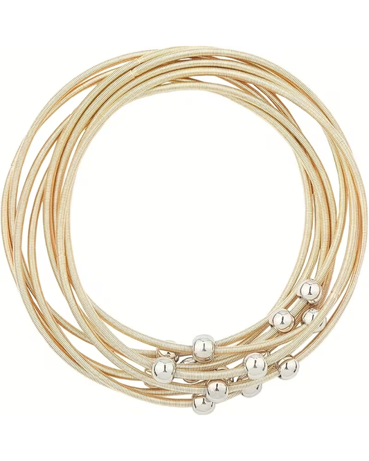 A stack of multi-layered snake skin bangles in a champagne gold color, accented with small polished silver beads, shown on a plain white background.