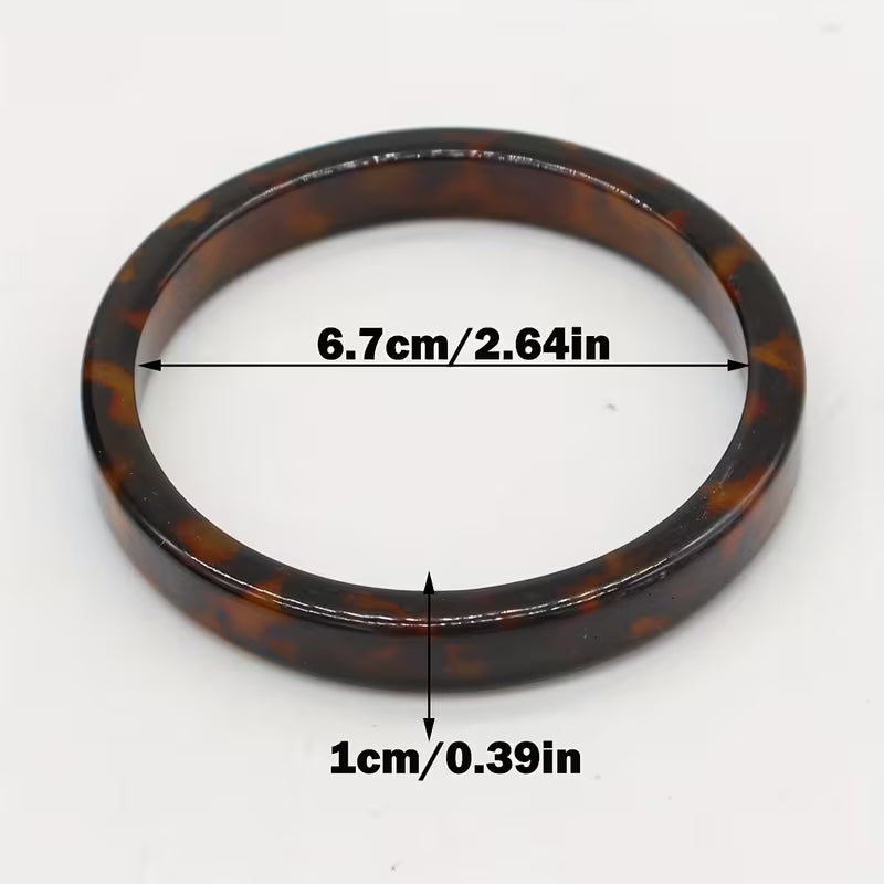 A tortoiseshell bangle watch band shown on a white background with dimension annotations indicating a width of 6.7cm (2.