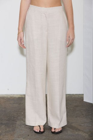 Beige wide-leg pants worn by a person on a plain background