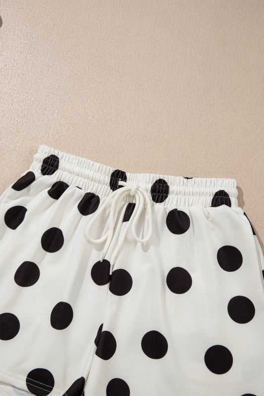 White pants with black polka dots on a beige background