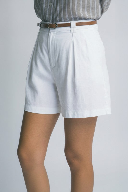 White shorts worn by a person on a plain background