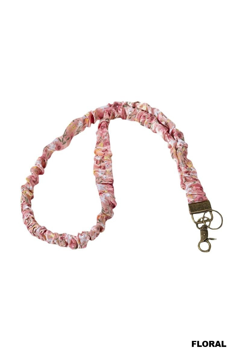 Floral patterned lanyard with a metal clasp on a white background