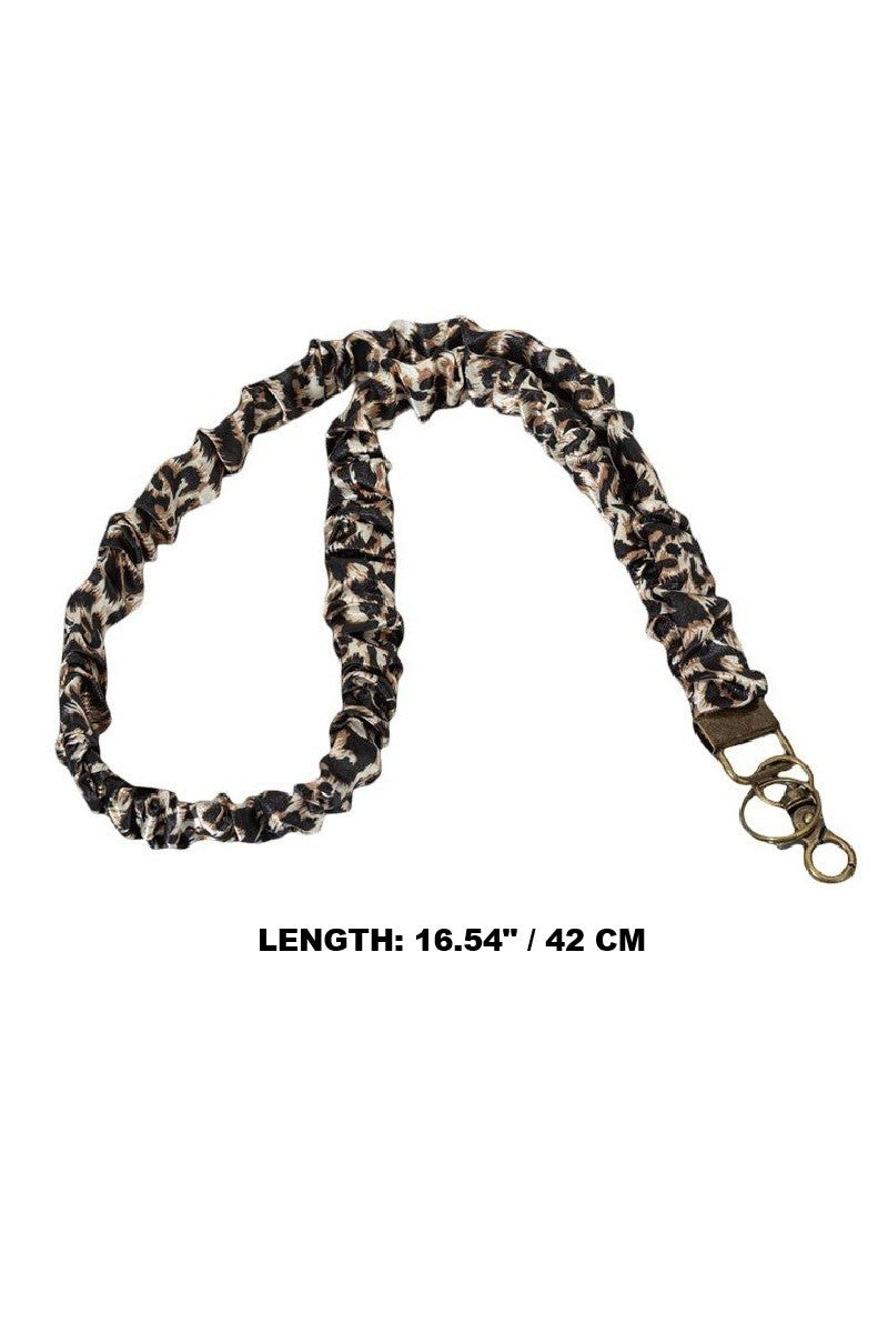 A leopard print fabric dog leash with a black and beige pattern, featuring a brass-colored metal clasp, shown on a white background with a text overlay indicating its length is 16.54 inches (42 cm).