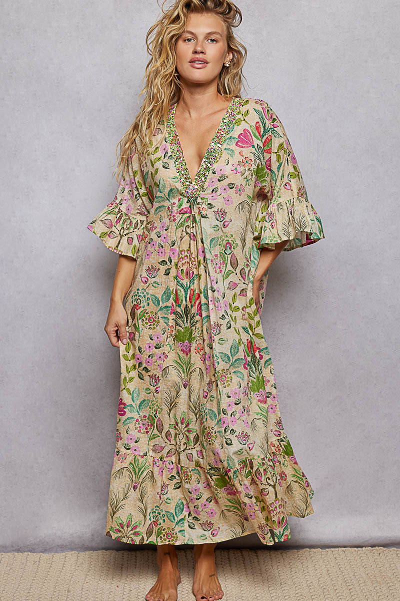 Woman wearing a floral dress against a plain background
