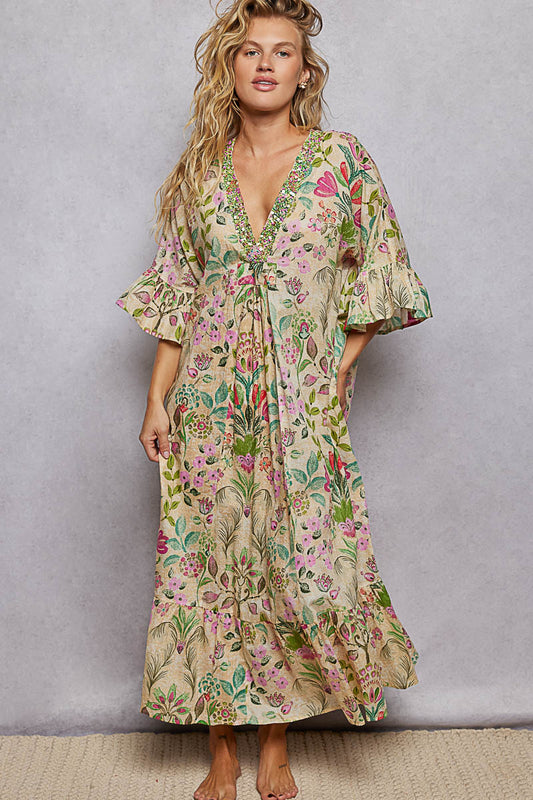 Woman wearing a floral dress against a plain background