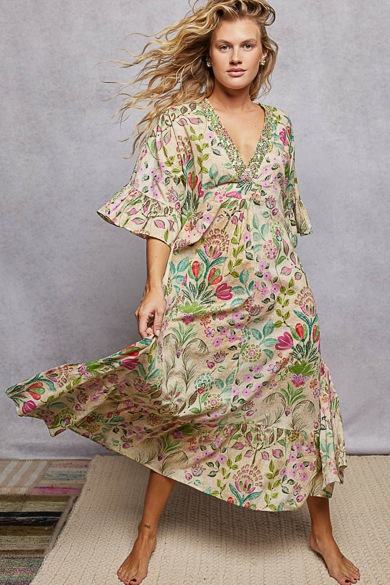 Woman wearing a floral dress against a gray background