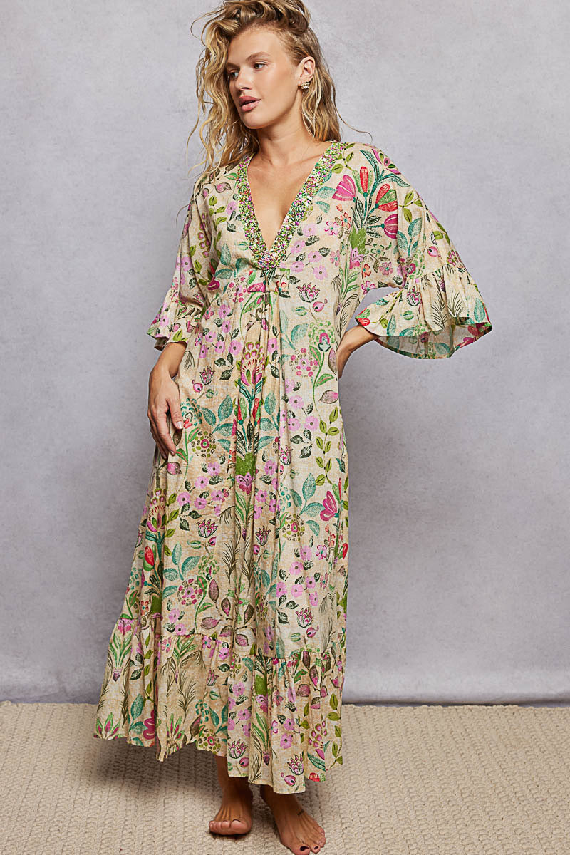Woman wearing a floral dress against a gray background