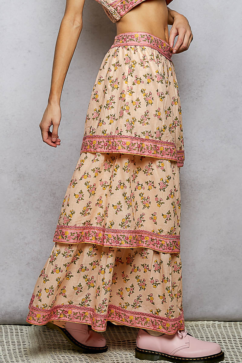 Beige floral maxi skirt with pink accents on a neutral background