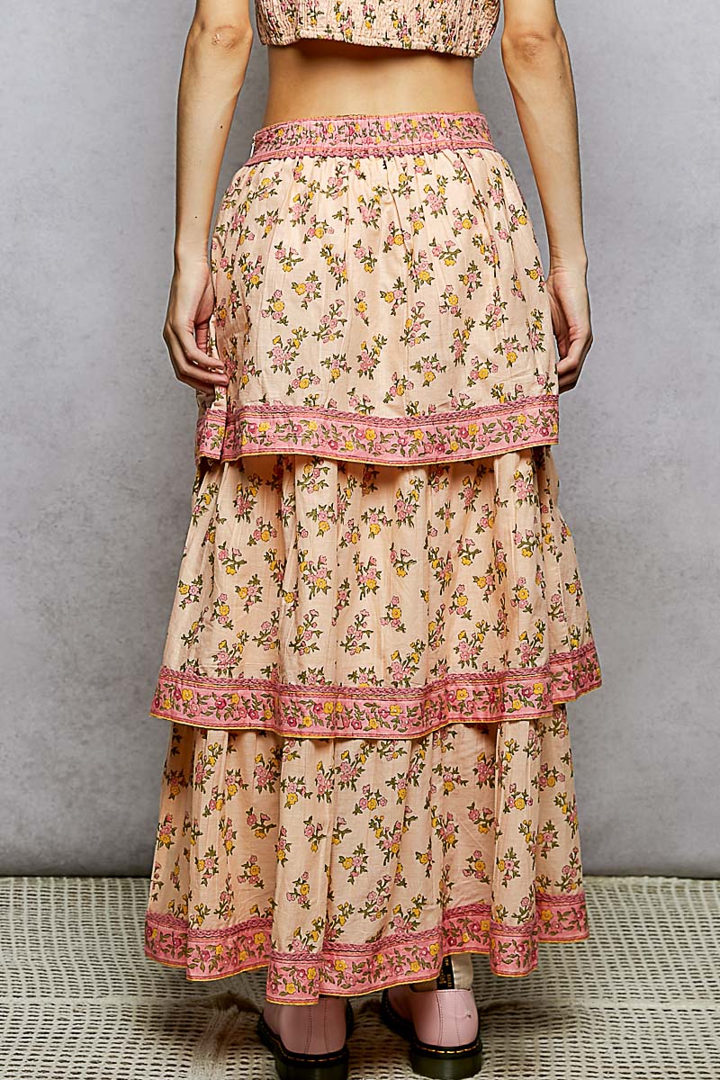 Floral tiered skirt with pink trim on a neutral background