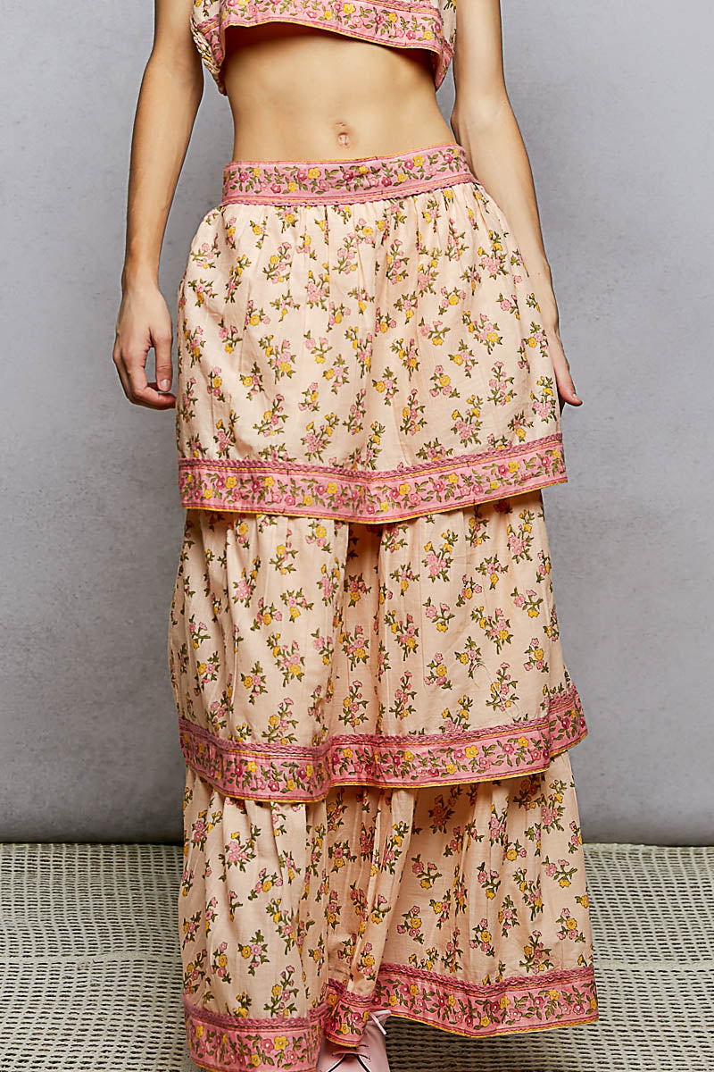 Floral tiered skirt with pink trim on a neutral background