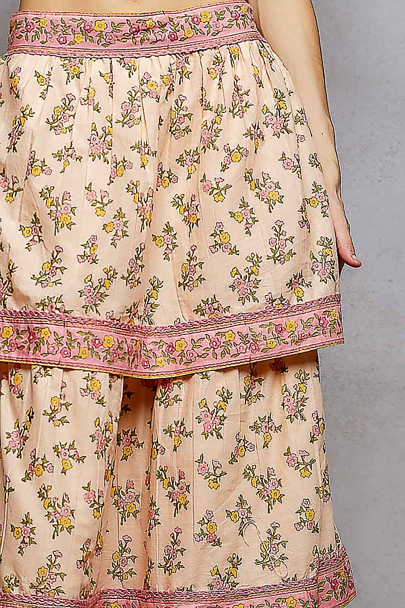Floral patterned skirt with pink trim on a plain background