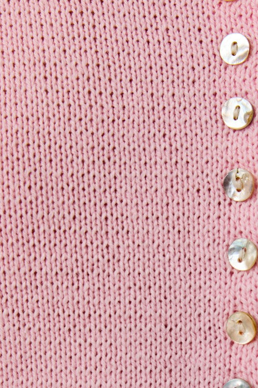 Close-up of a pink knitted fabric with button details