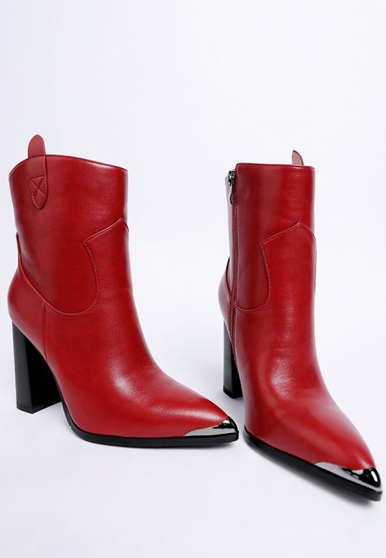 Pair of red leather boots with black soles on a white background