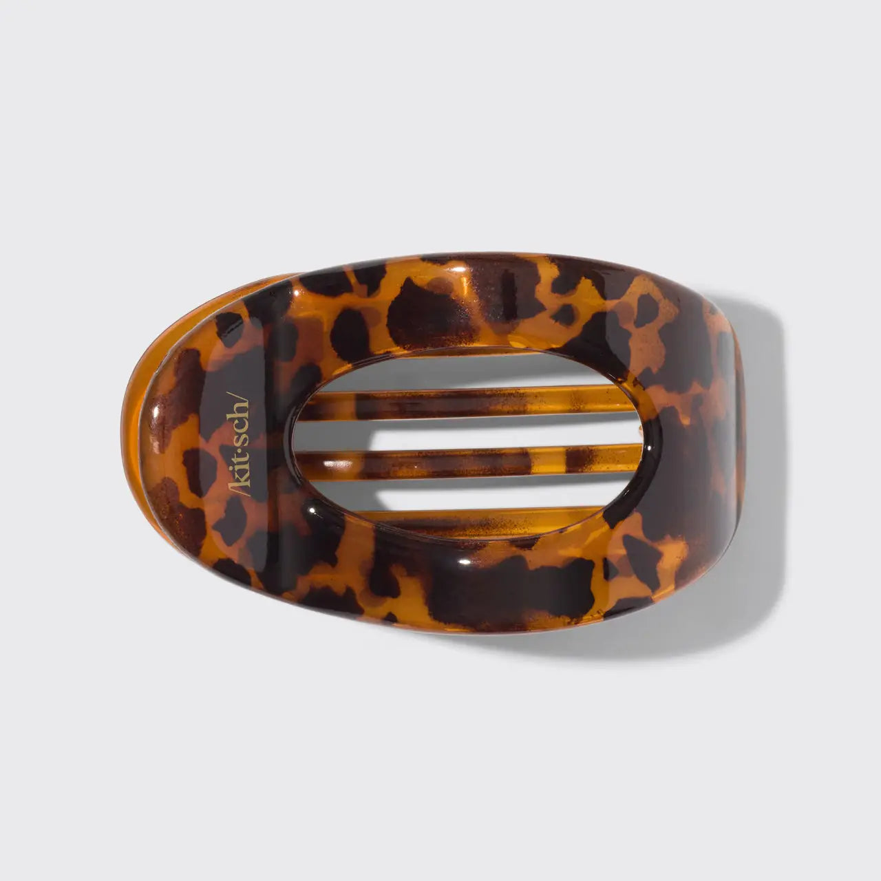 Tortoiseshell patterned hair clip on a light gray background