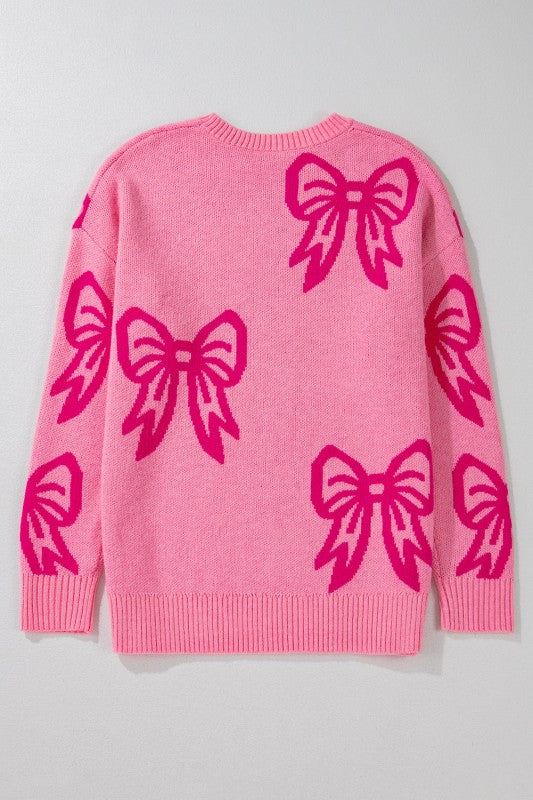 Pink sweater with large pink bows on a light gray background