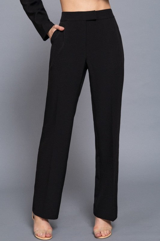 Black pants worn by a person on a gray background