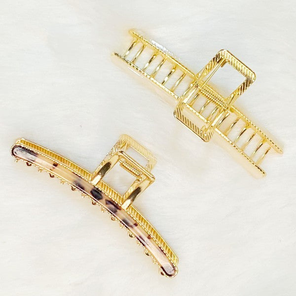 Two gold hair clips on a white background