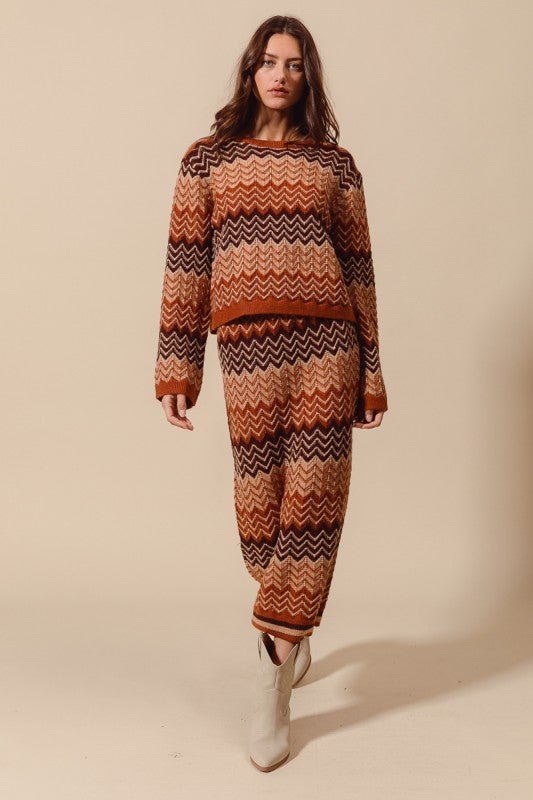 Woman wearing a patterned sweater and pants set on a beige background