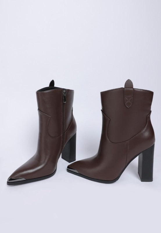 Pair of brown leather ankle boots with black block heels on a white background