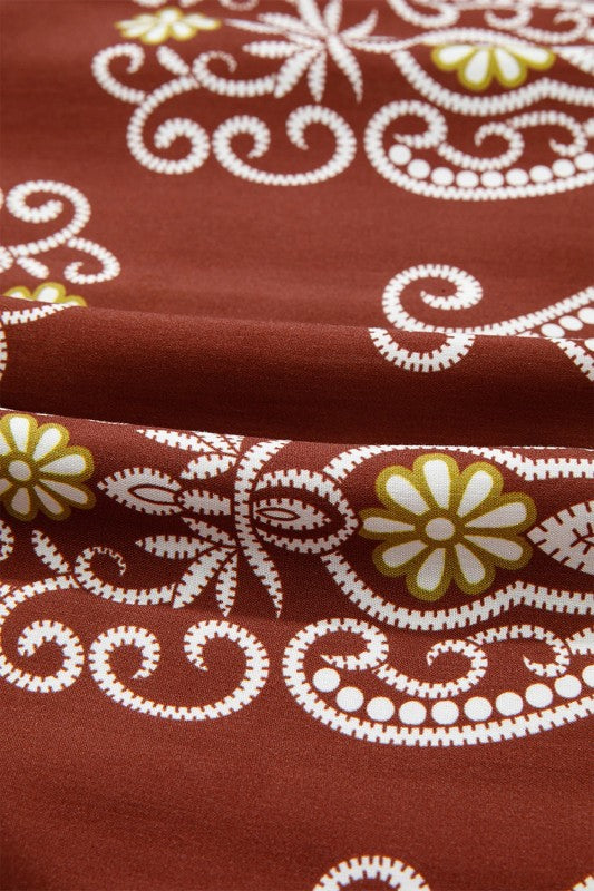 Close-up of brown fabric with white floral and swirl patterns