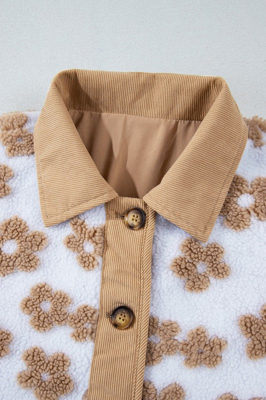 Tan corduroy shirt collar with buttons on a textured beige background